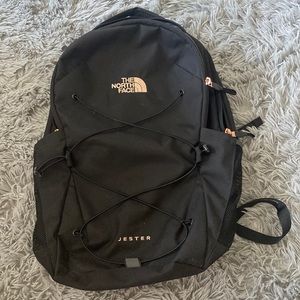 Black north face backpack with rose gold writing